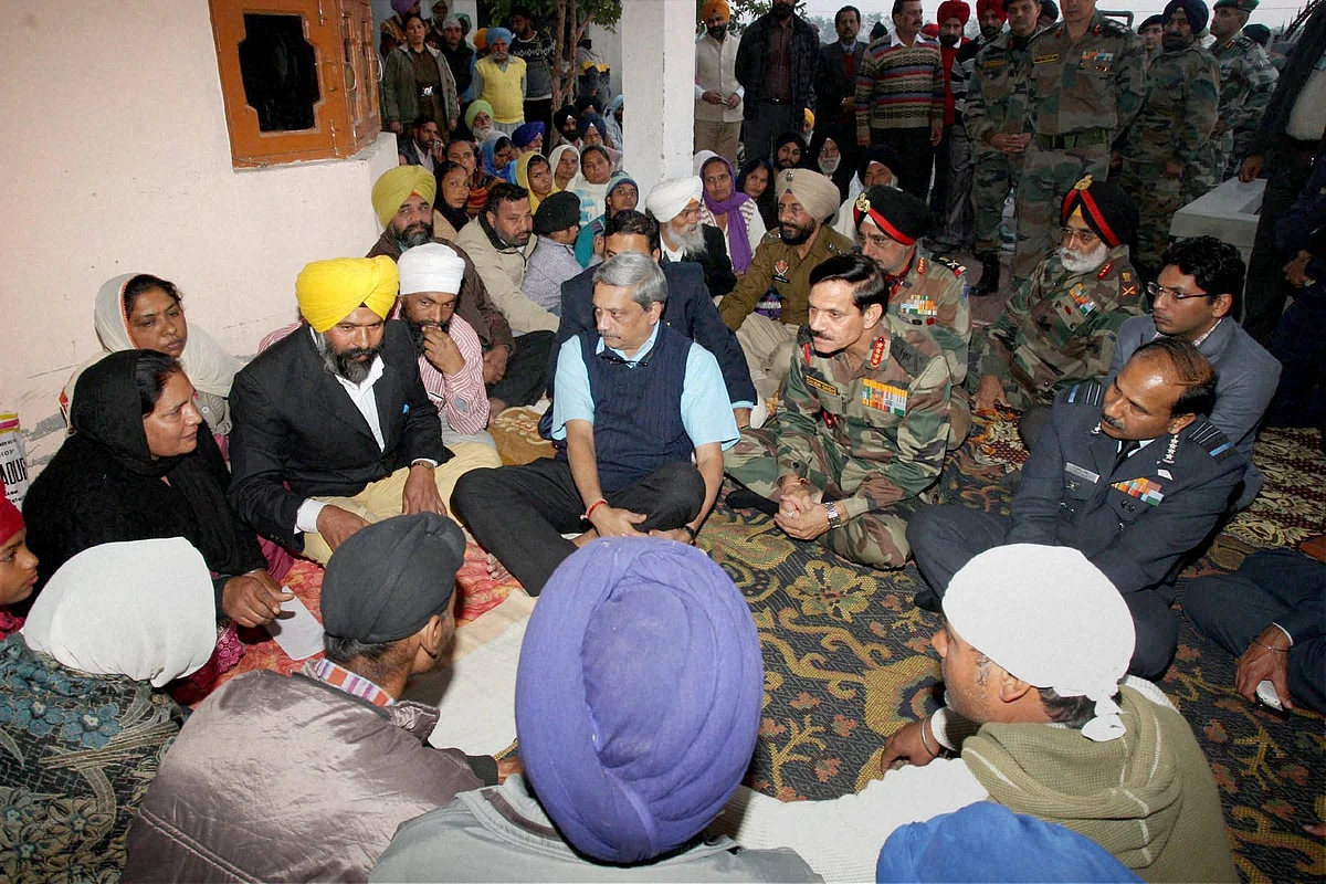 Union Minister for Defence Manohar Parrikar along with the Air Chief Marshal Arup Raha and the Chief of Army Staff, General Dalbir Singh offering condolences to the family of the late Lance Naik Kulwant Singh at Chak Sarif village in Gurdaspur on Wednesday. (Photo: PTI)
