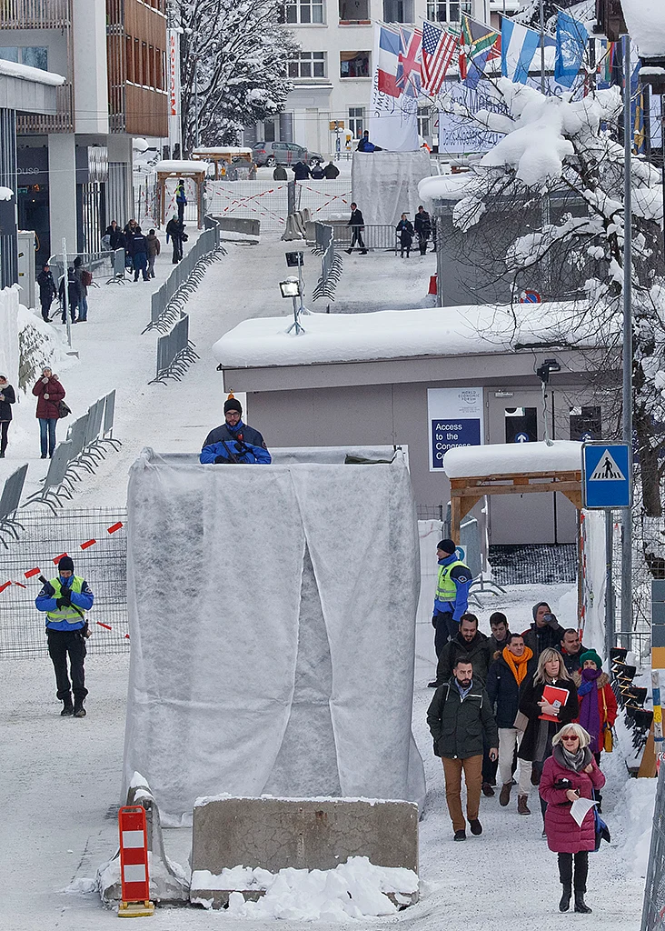 Participants walk through the security zone at the congress
center. (Photo: AP)