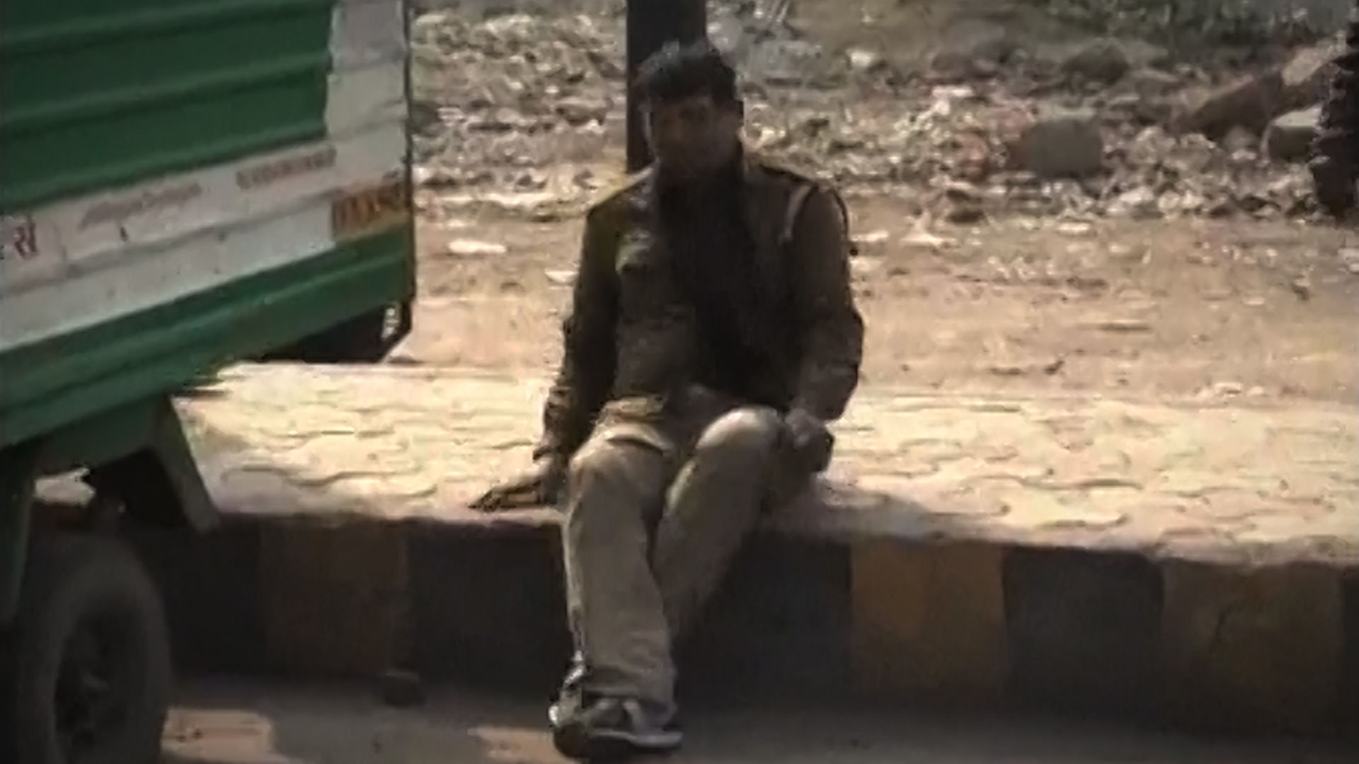 The drunk cop in Kanpur seen sitting down and recomposing himself. (Photo: ANI screengrab)