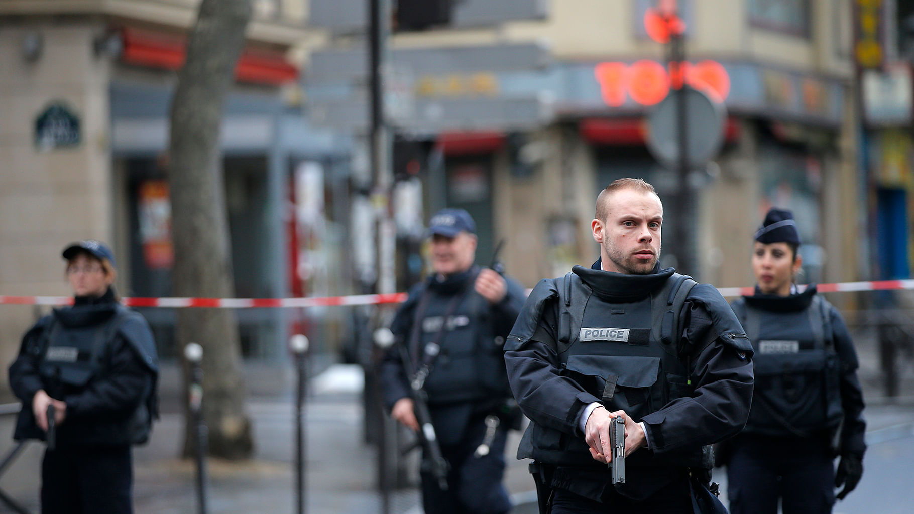 Police officers secure the perimeter near the scene of a fatal shooting which took place at a police station in Paris on January 7, 2016. (Photo: AP)