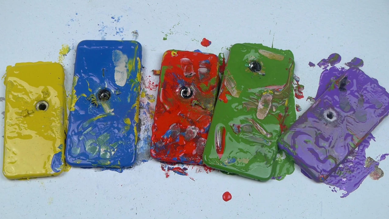 The iPhones after being dipped in paint and shot by a nail gun. (Photo: AP/Newsflare screengrab)