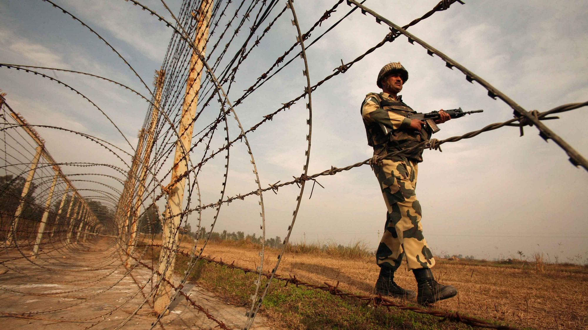 An Indian Border Security Force (BSF) soldier patrols near the fenced border with Pakistan in Suchetgarh, southwest of Jammu. (Photo: Reuters)