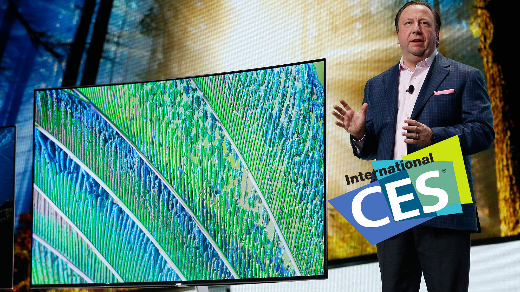 Joe Stinziano, executive vice president of Samsung Electronics America, stands next to Samsung SUHD TVs during a Samsung news conference at CES Press Day at CES International, Tuesday, January 5, 2016, in Las Vegas. (Photo: AP)   