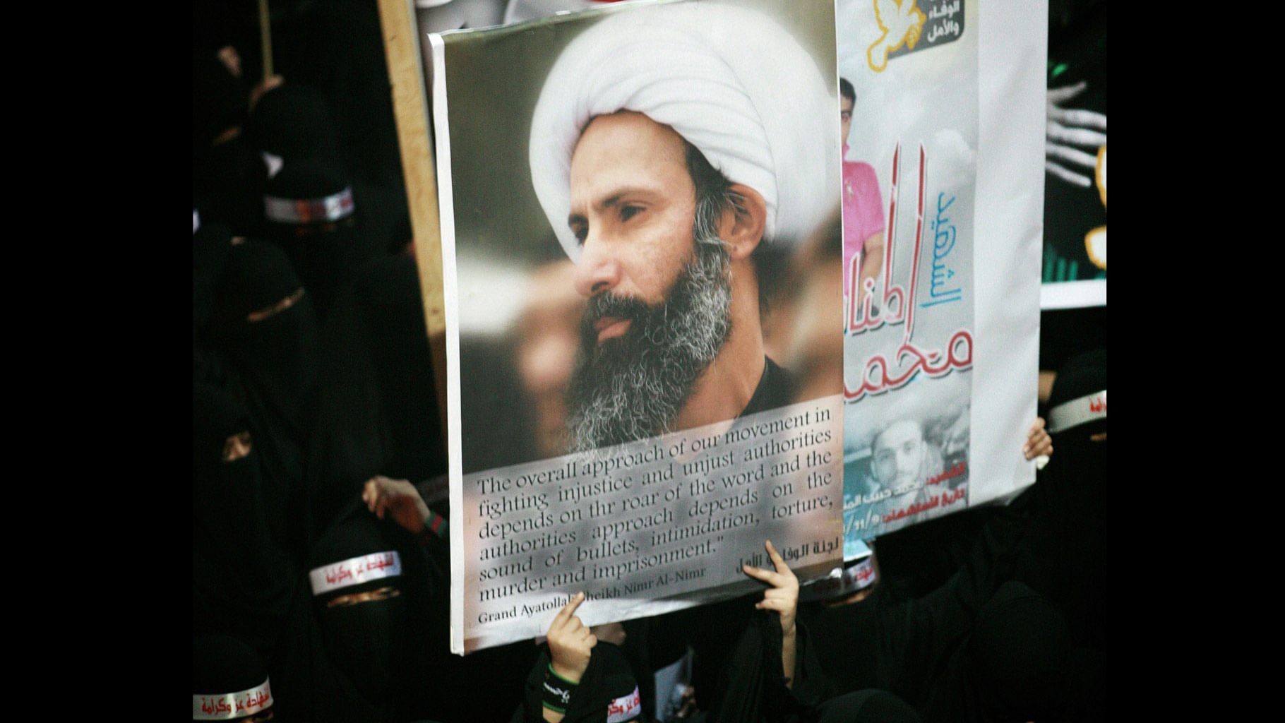 A Saudi anti-government protester carries a poster with the image of executed Shiite cleric Sheikh Nimr al-Nimr. (Photo: AP)