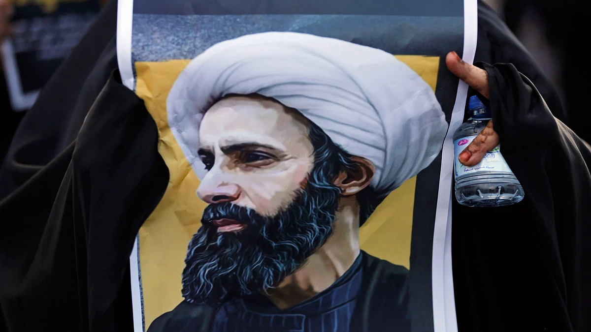 A protester holding a poster depicting Shiite cleric Sheikh Nimr al-Nimr, who witj 46 others, was executed by Saudi Arabia. (Photo: AP)