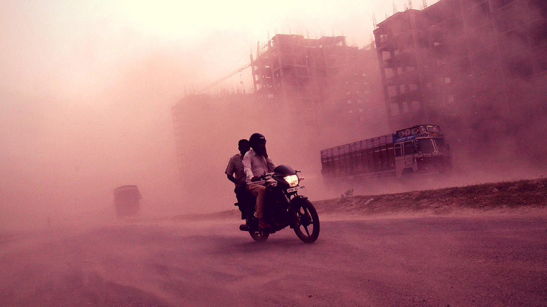 

Men ride a motorcycle through a heavy dust storm along a road in Greater Noida on the outskirts of New Delhi October 23, 2012. (Photo: Reuters)