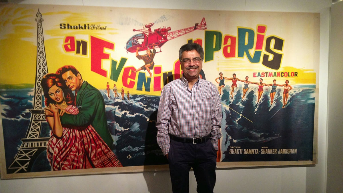 The author in front of a poster of <i>An</i> <i>Evening in Paris. </i>(Photo: Khalid Mohammed)