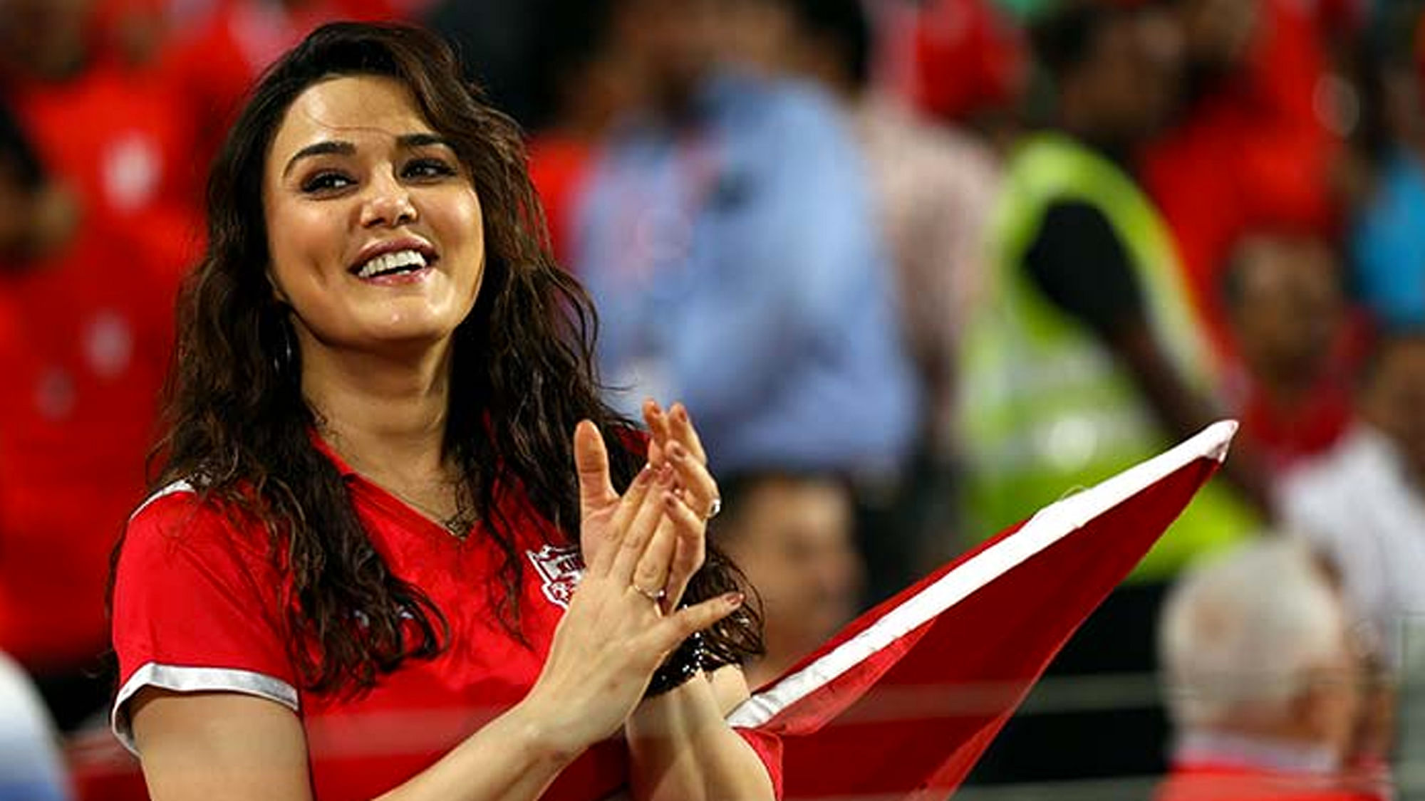 An enthusiastic Preity Zinta cheering on her IPL team Kings XI Punjab at a match.