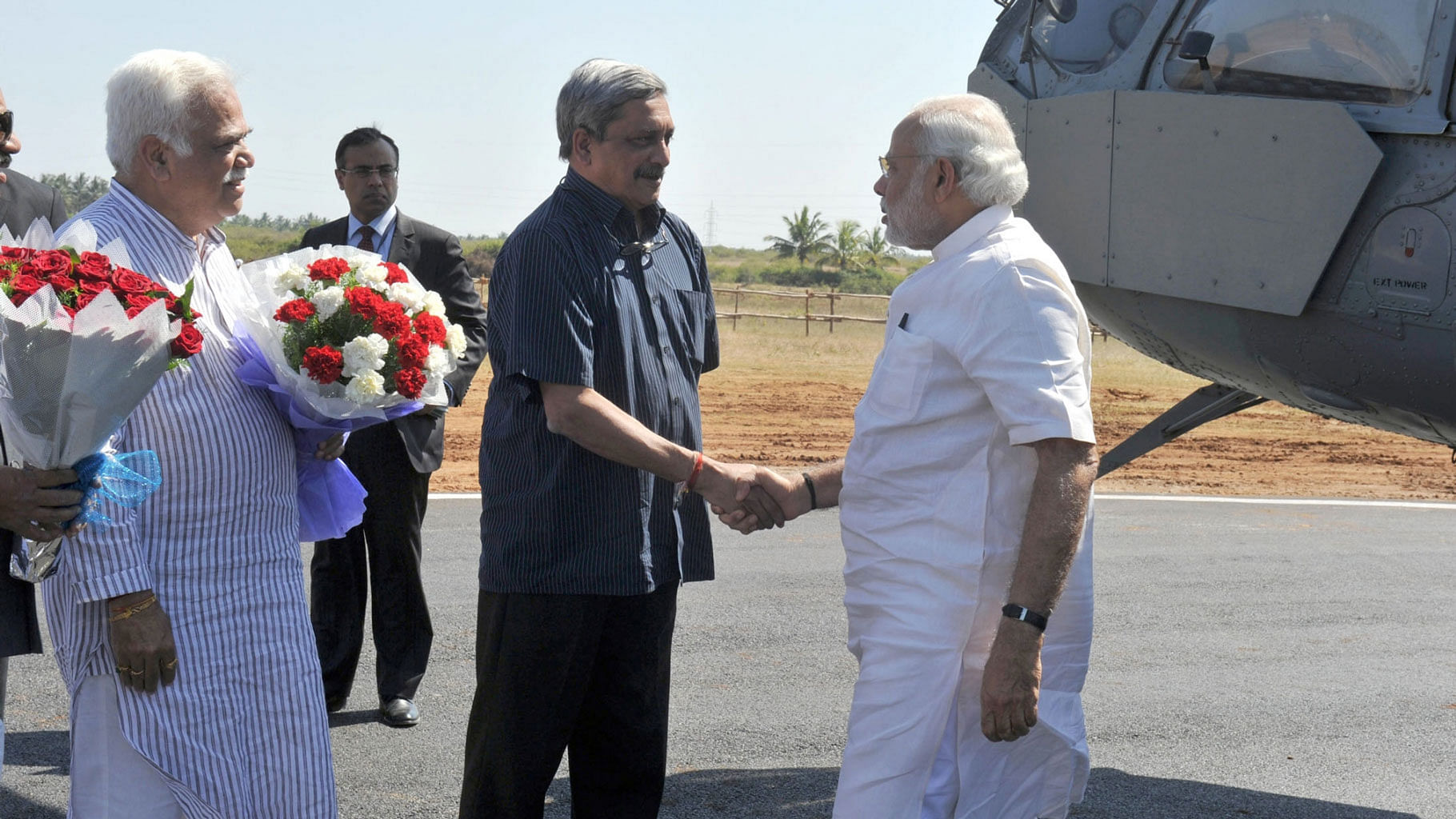 Defence Minister Manohar Parrikar receives Prime Minister Narendra Modi at the HAL Helicopter Factory, at Tumakuru, Karnataka on 3 January, 2016. (Photo: IANS)