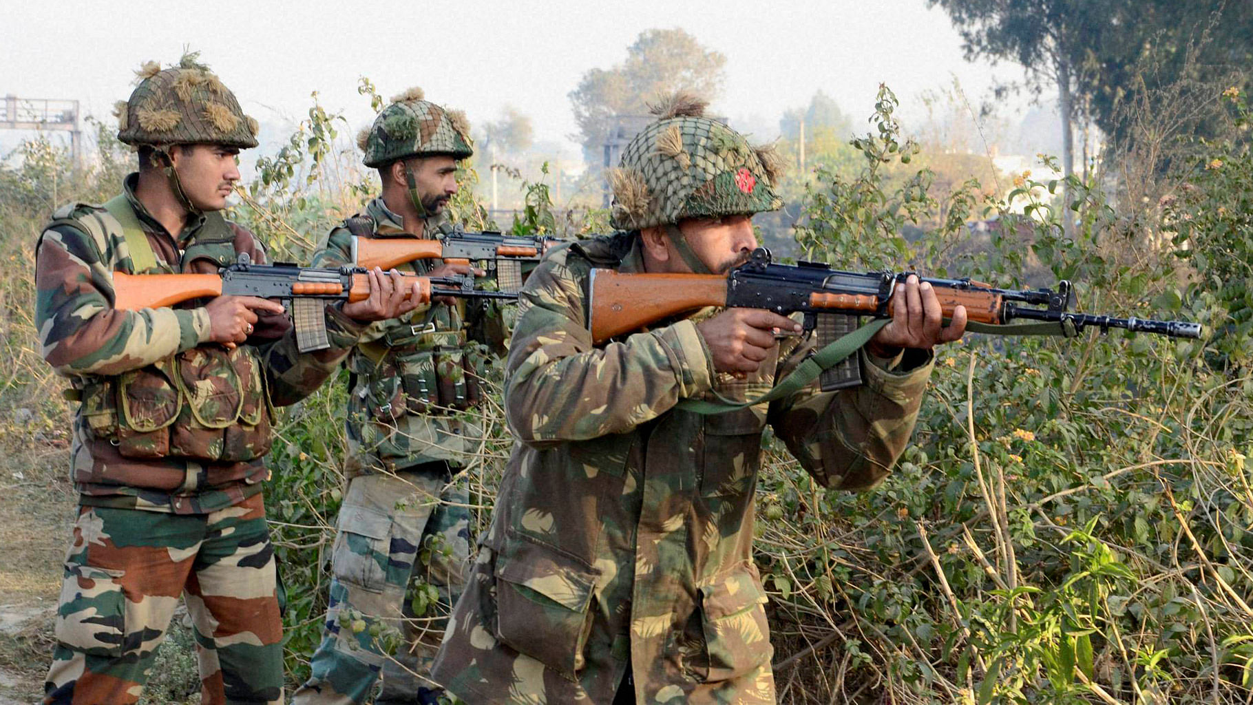Army soldiers conduct a search operation in a forest area outside the Air Force Base in Pathankot on Sunday. (Photo: PTI)&nbsp;
