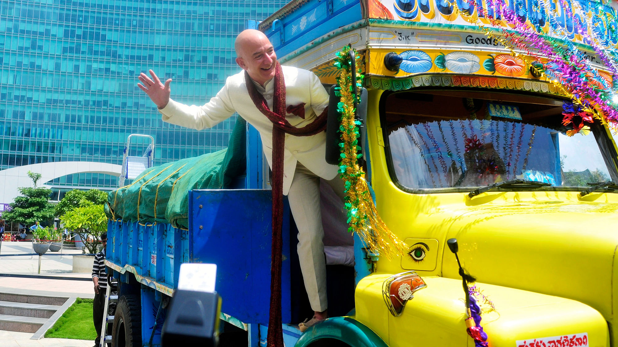 Jeff Bezos, founder and CEO of Amazon, poses as he stands on a supply truck at the premises of a shopping mall in Bangalore in 2014.
