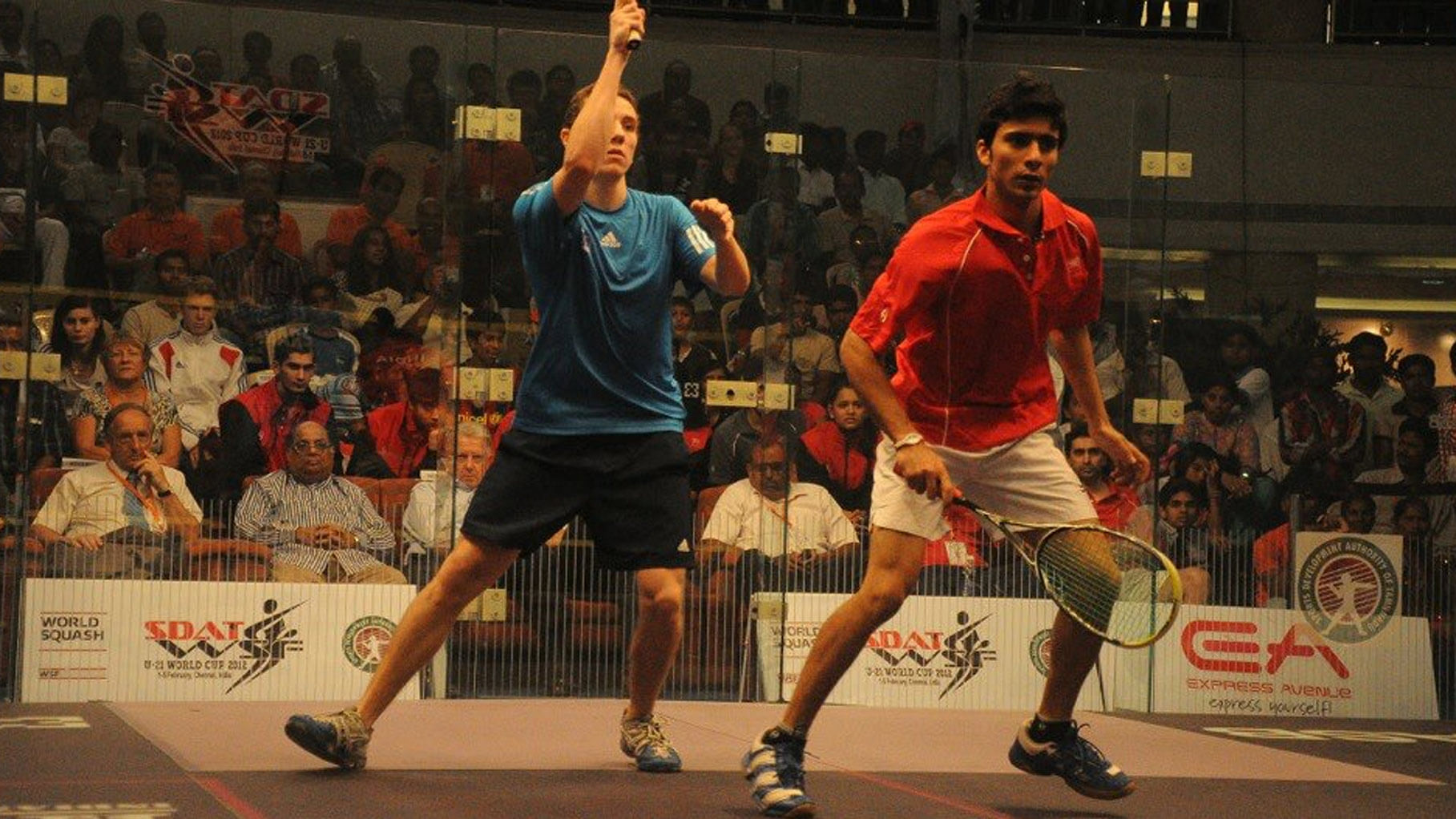 National-level squash player Ravi Dixit (R) during a match. 