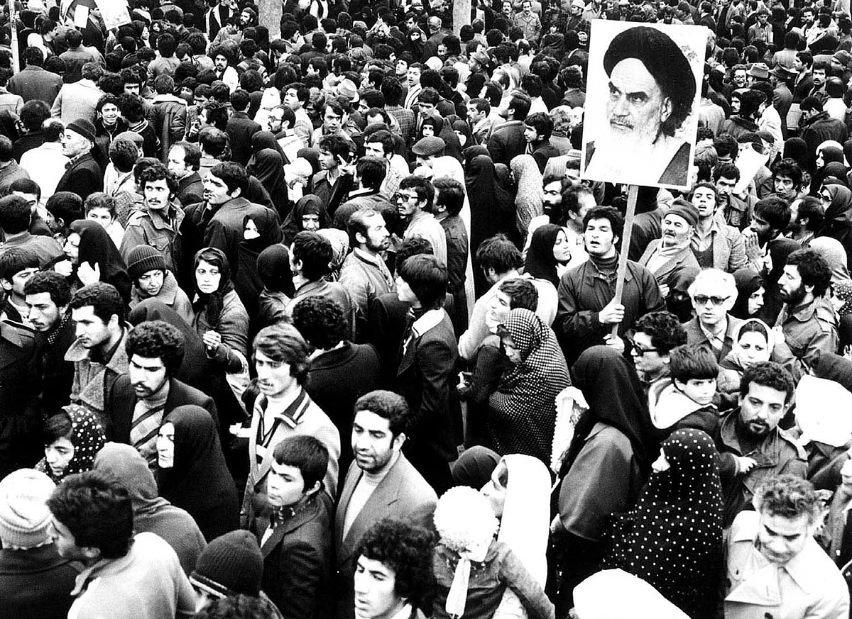 Supporters of the leader and founder of the Islamic revolution Ayatollah Khomeini hold his picture in Tehran during the country’s revolution in February 1979. (File Photo: Reuters) 