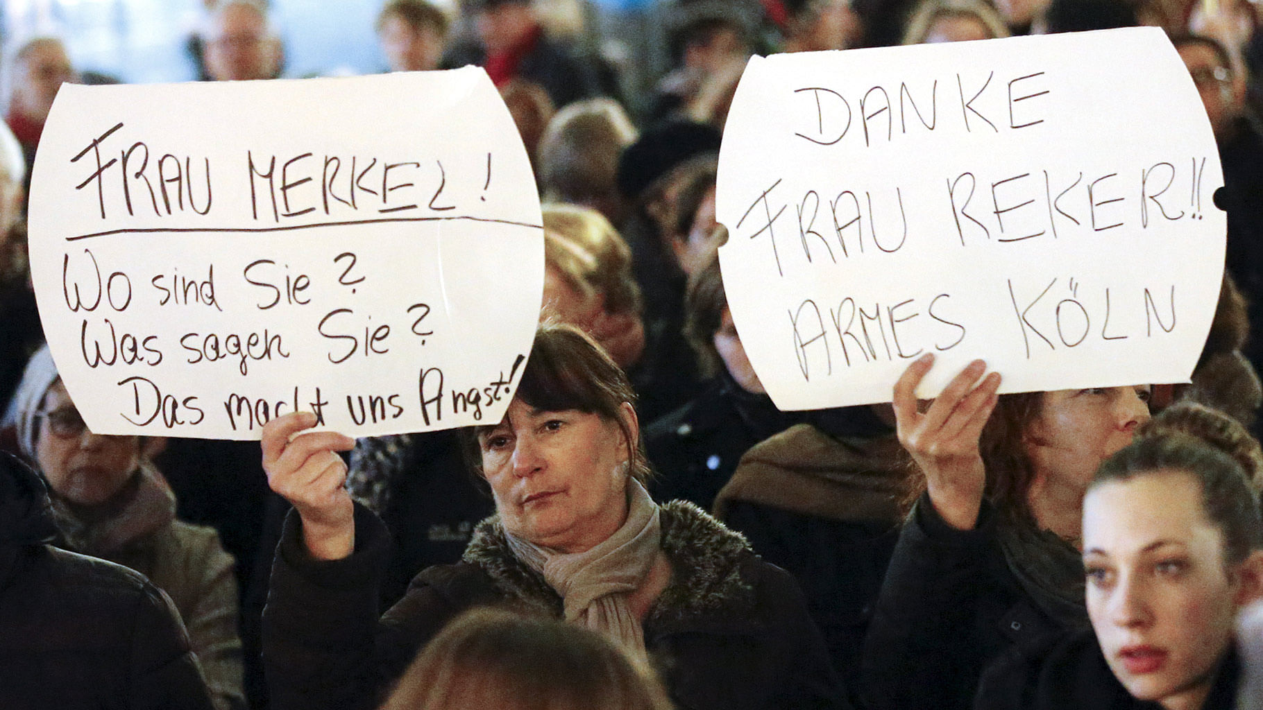 Women hold up placards that read “Mrs. Merkel: Where are you? What are you saying? This worries us!”  during a protest in front of the Cologne Cathedral. (Photo: Reuters)