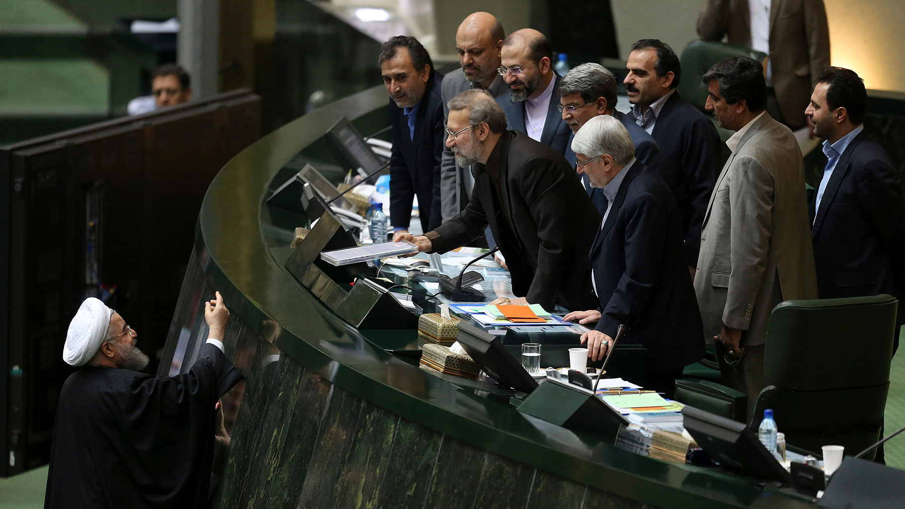 In this file photo, Iranian President Hassan Rouhani, left,
presents a draft of the country’s new budget and sixth development plan. (Photo: AP) &nbsp; &nbsp;  &nbsp;