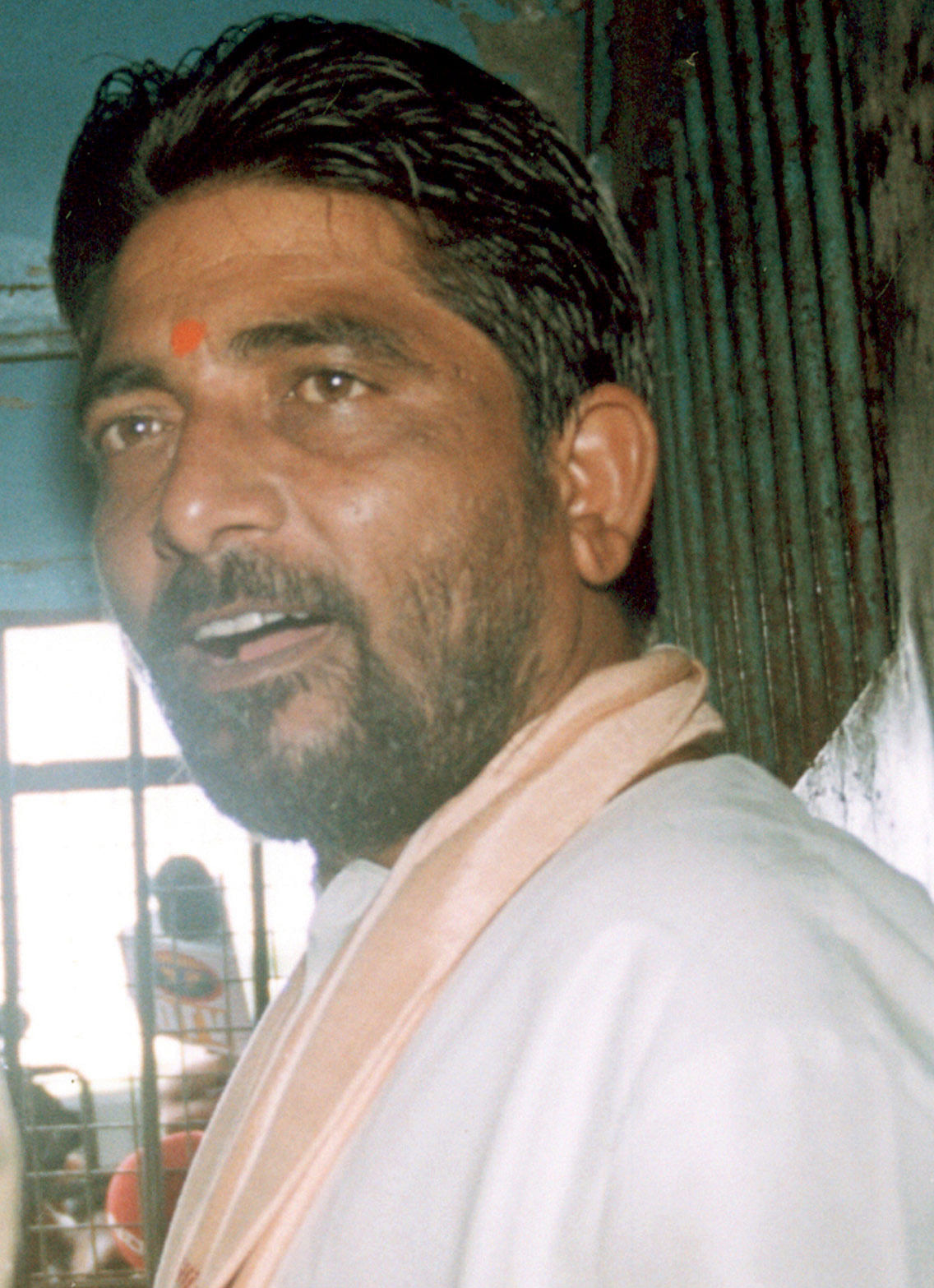 Hindu activist and ringleader Dara Singh is seated in a police van in Bhubaneswar.&nbsp;