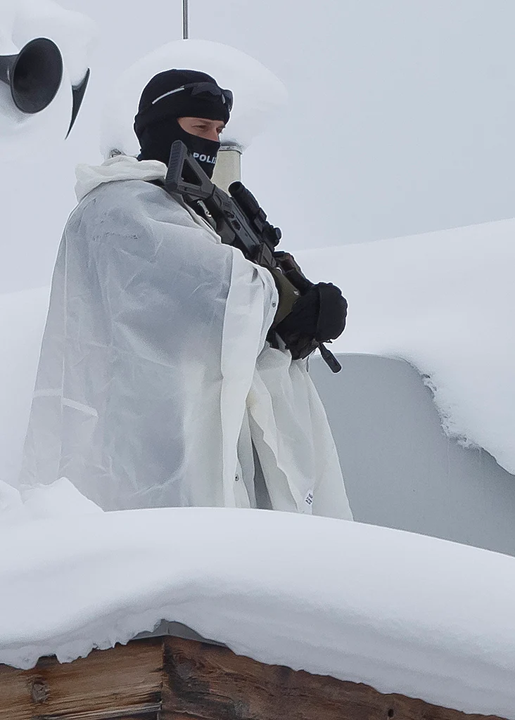 A police officer patrols on a roof top of a hotel near the
congress center in Davos. (Photo: AP)