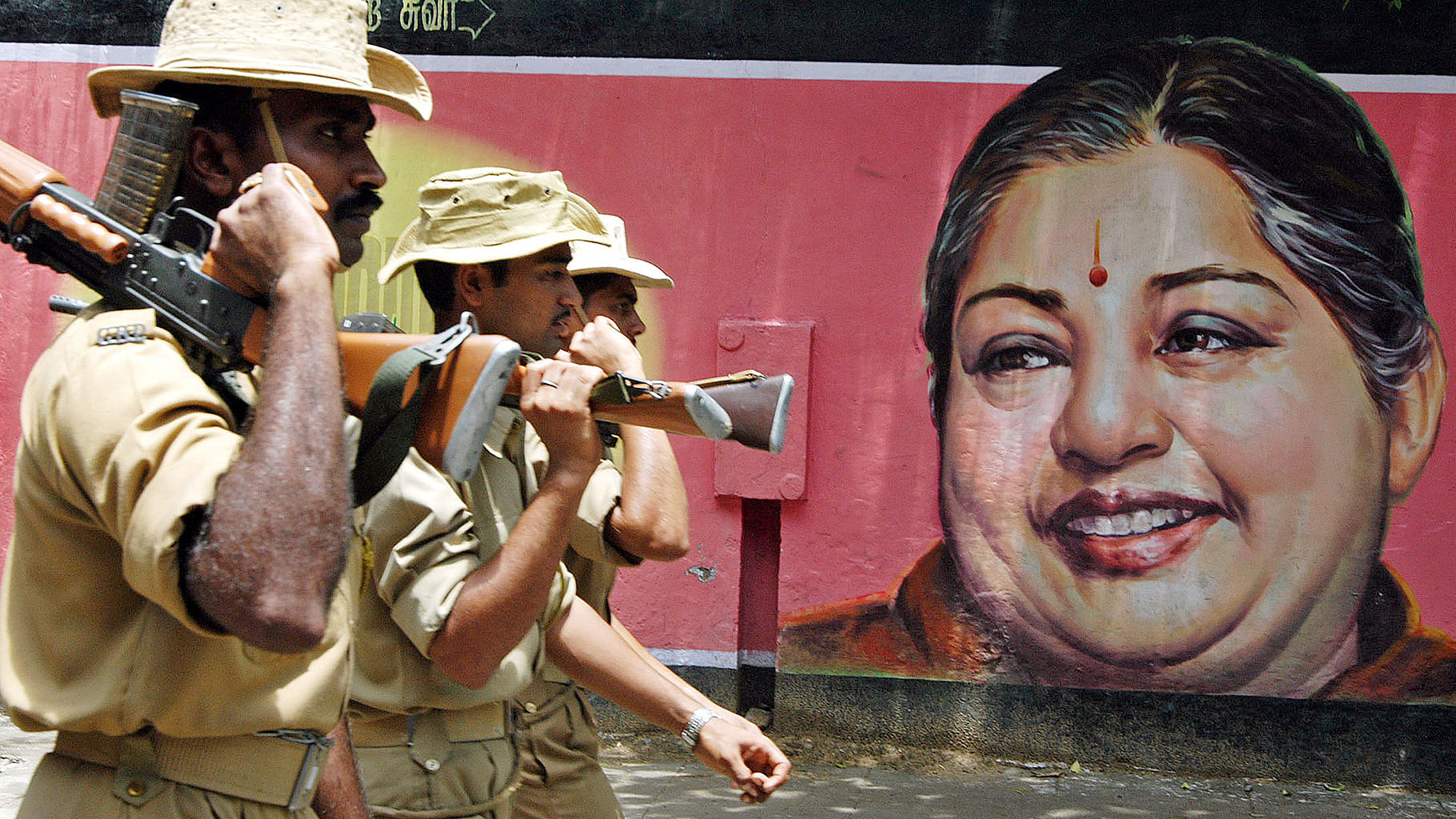 Chennai police officers are seen here, with a poster of Chief Minister of Tamil Nadu, J Jayalalitha, in the background. (Photo: Reuters) &nbsp;    
