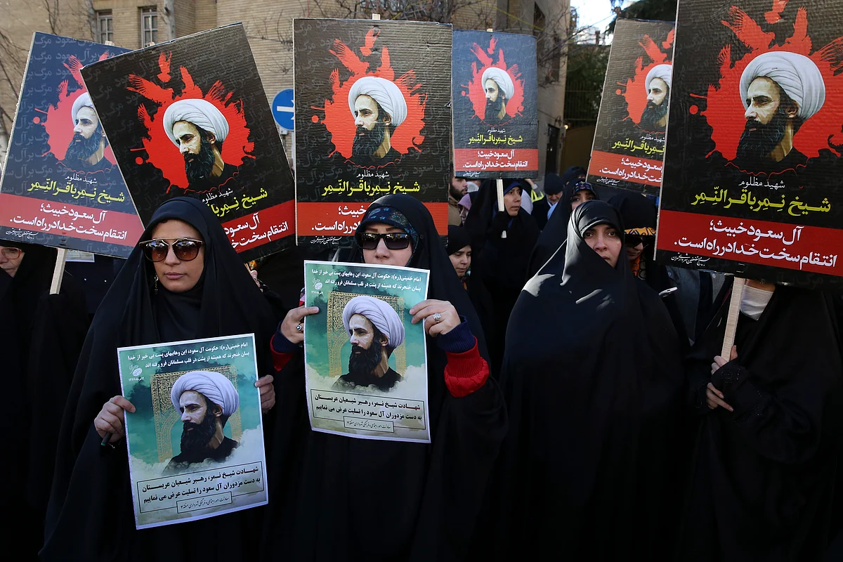 Iranian demonstrators hold posters of Sheikh Nimr al-Nimr, during a protest denouncing his execution, in front of the Saudi Embassy, in Tehran. (Photo: AP)