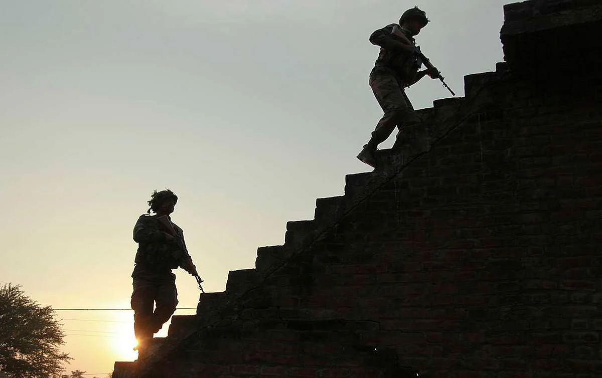 Indian army soldiers climb up the stairs of a residential building outside the Indian air force base in Pathankot. (Photo: AP) 