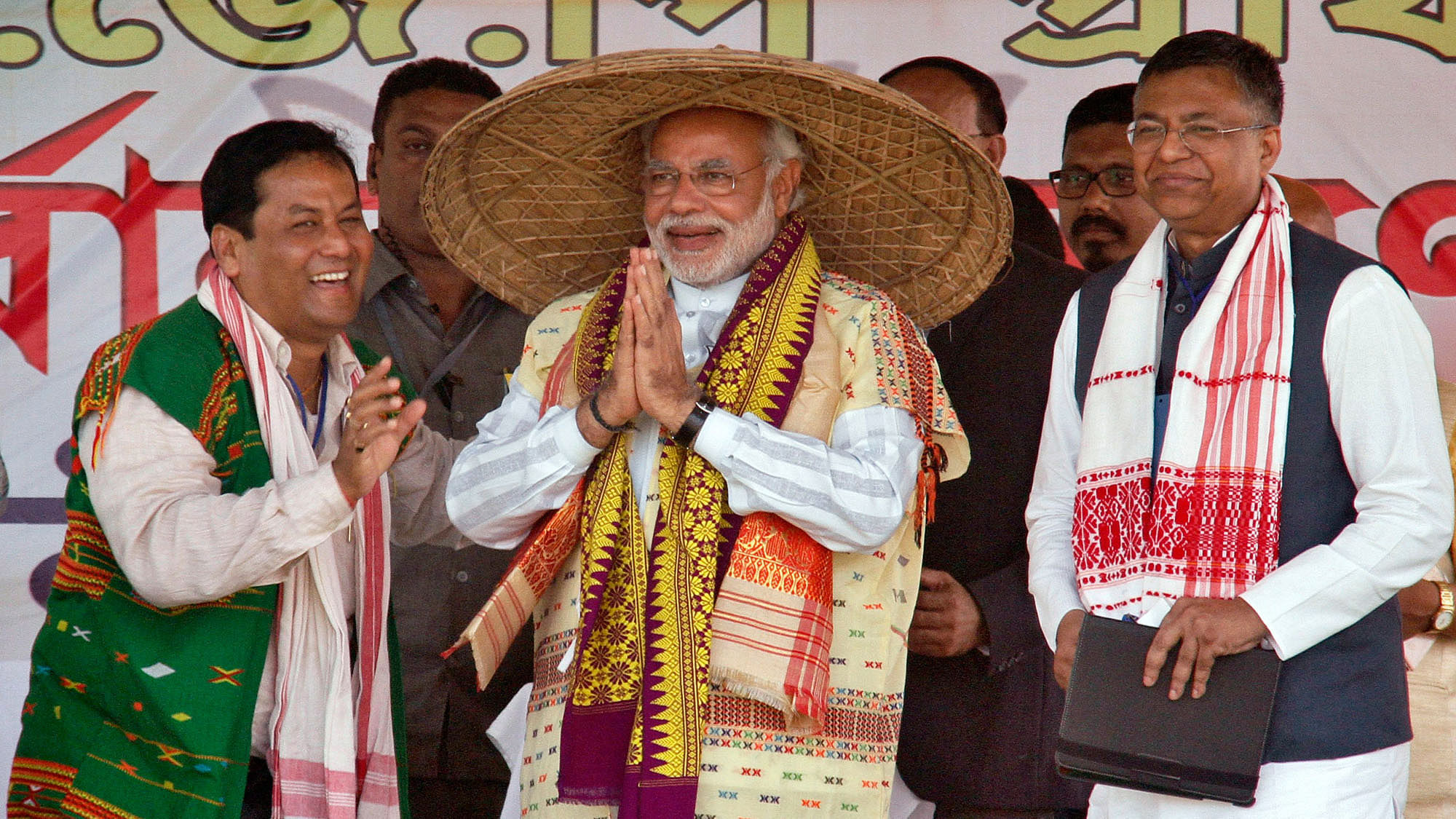 

Narendra Modi wearing a “Japi” (a traditional hat of Assam) receives a wooden Rhino by his supporters during a rally ahead of the 2014 general elections, at Guwahati. (Photo: Reuters)