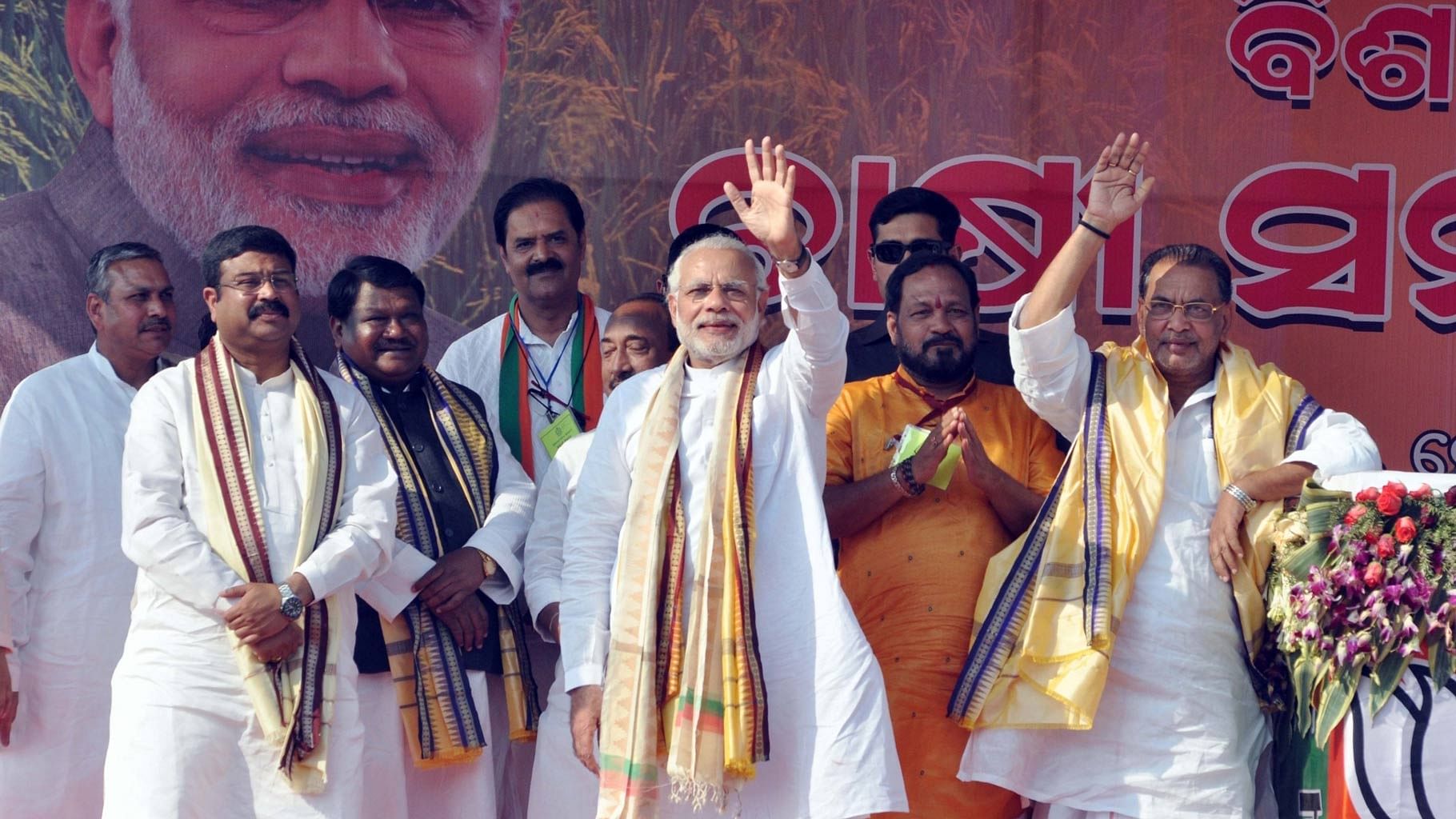  Prime Minister Narendra Modi with Union Agriculture Minister Radha Mohan Singh and Union Petroleum Minister Dharmendra Pradhan during a farmers’ rally in Bargarh district of Odisha on 21 February 2016.&nbsp;