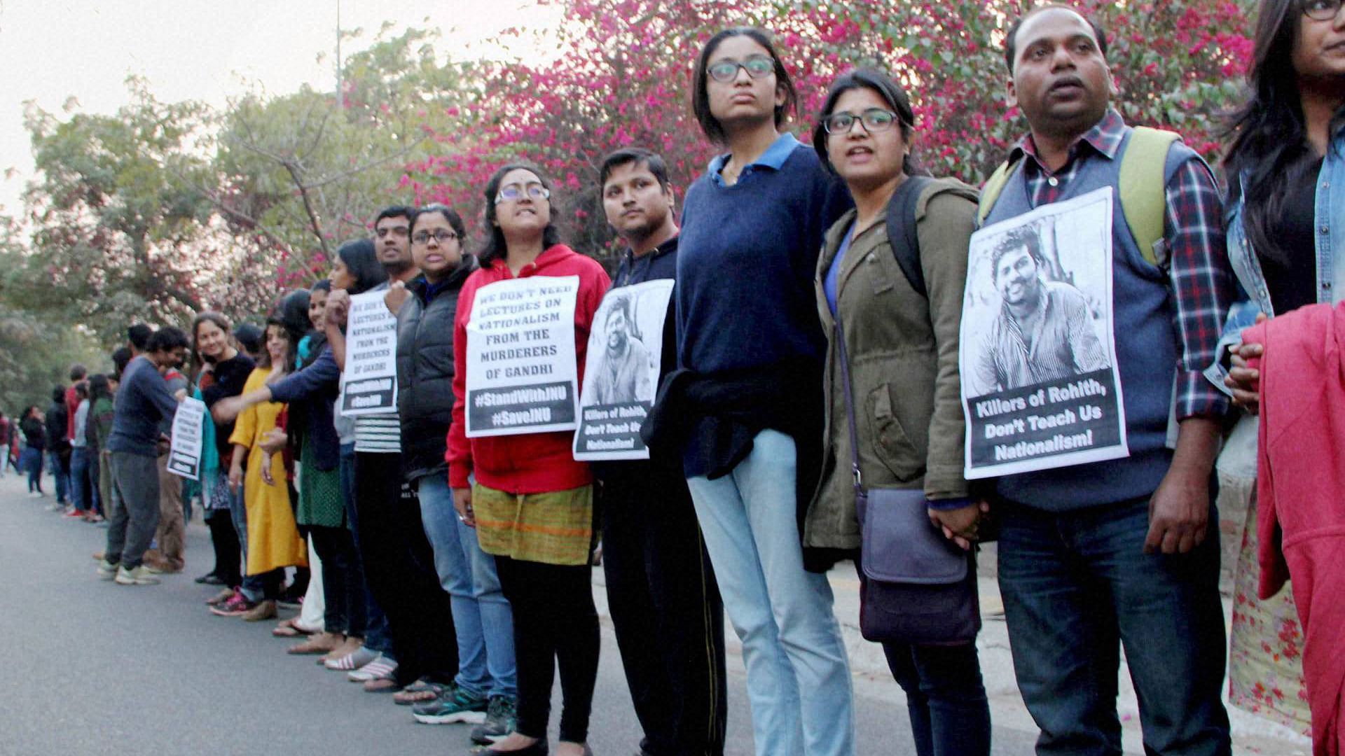 JNU teachers &amp; students form a human chain inside the campus to protest JNUSU President Kanhaiya Kumar’s arrest in New Delhi. (Photo: PTI) 