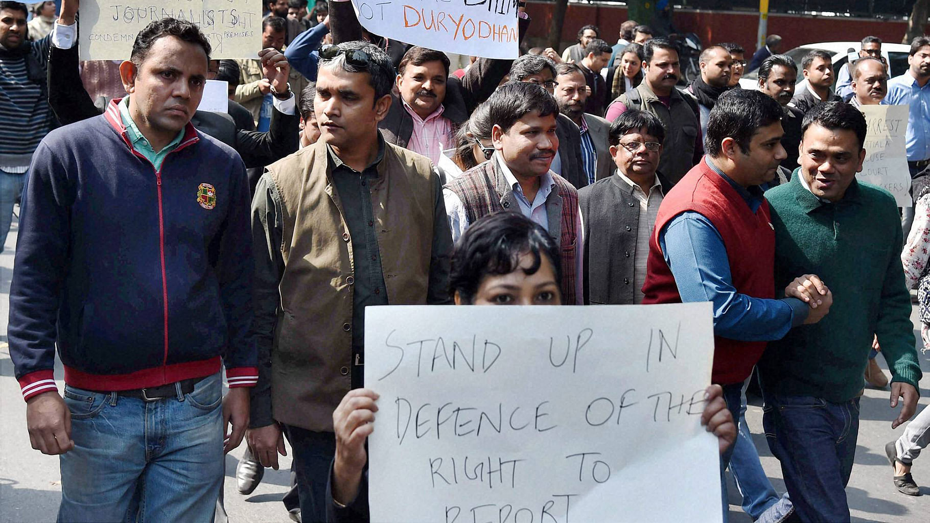 Journalists display placards at a protest march from Press Club of India to the Supreme Court in protest against the Mondays attack on media persons and JNU students. (Photo: PTI)