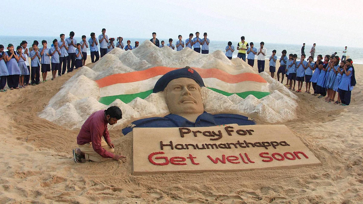 Renowned sand artist Sudarshan Patnaik prays for Hanumanthappa. (Photo: PTI)