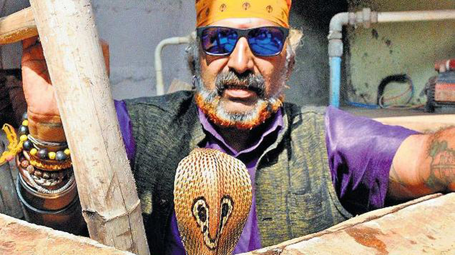 Snake Shyam with snake. (Photo Courtesy: The News Minute)