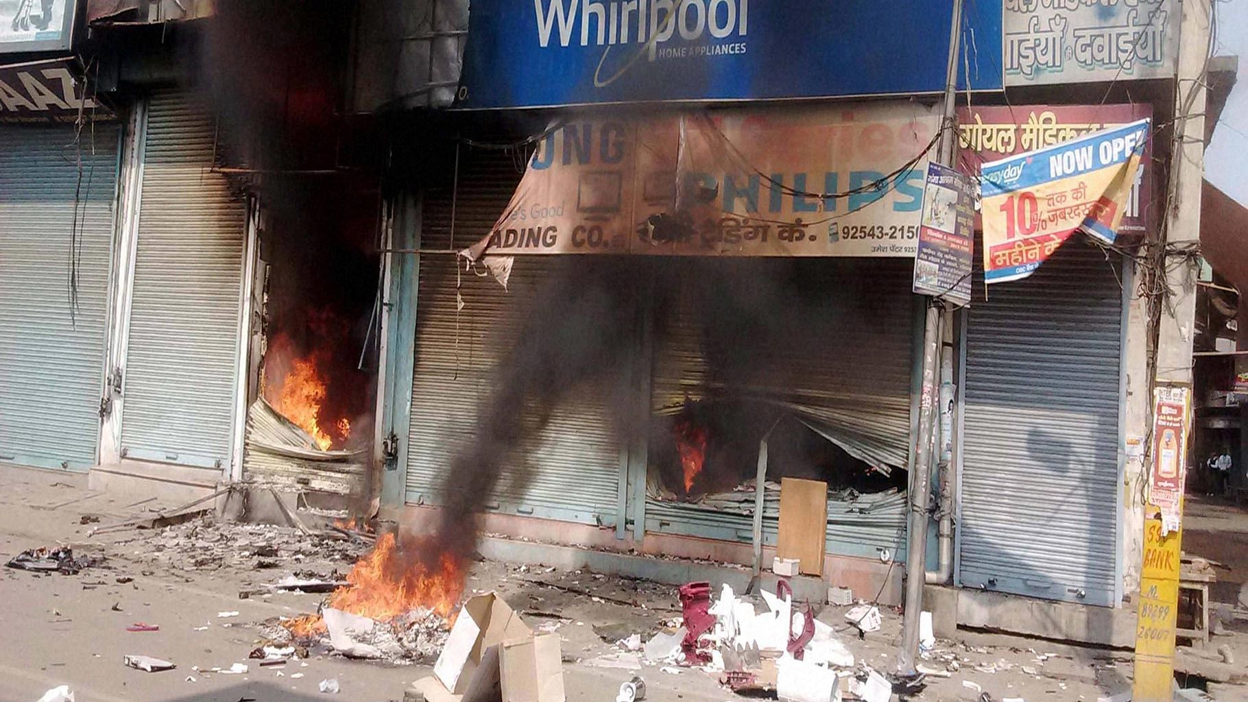 Shops set on fire as the Jat agitation for reservation intensified in Sonepat on 20 January 2015. (Photo: PTI)