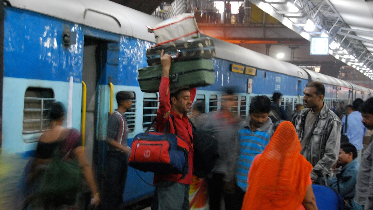 A porter carrying luggage at a Delhi railway station. 