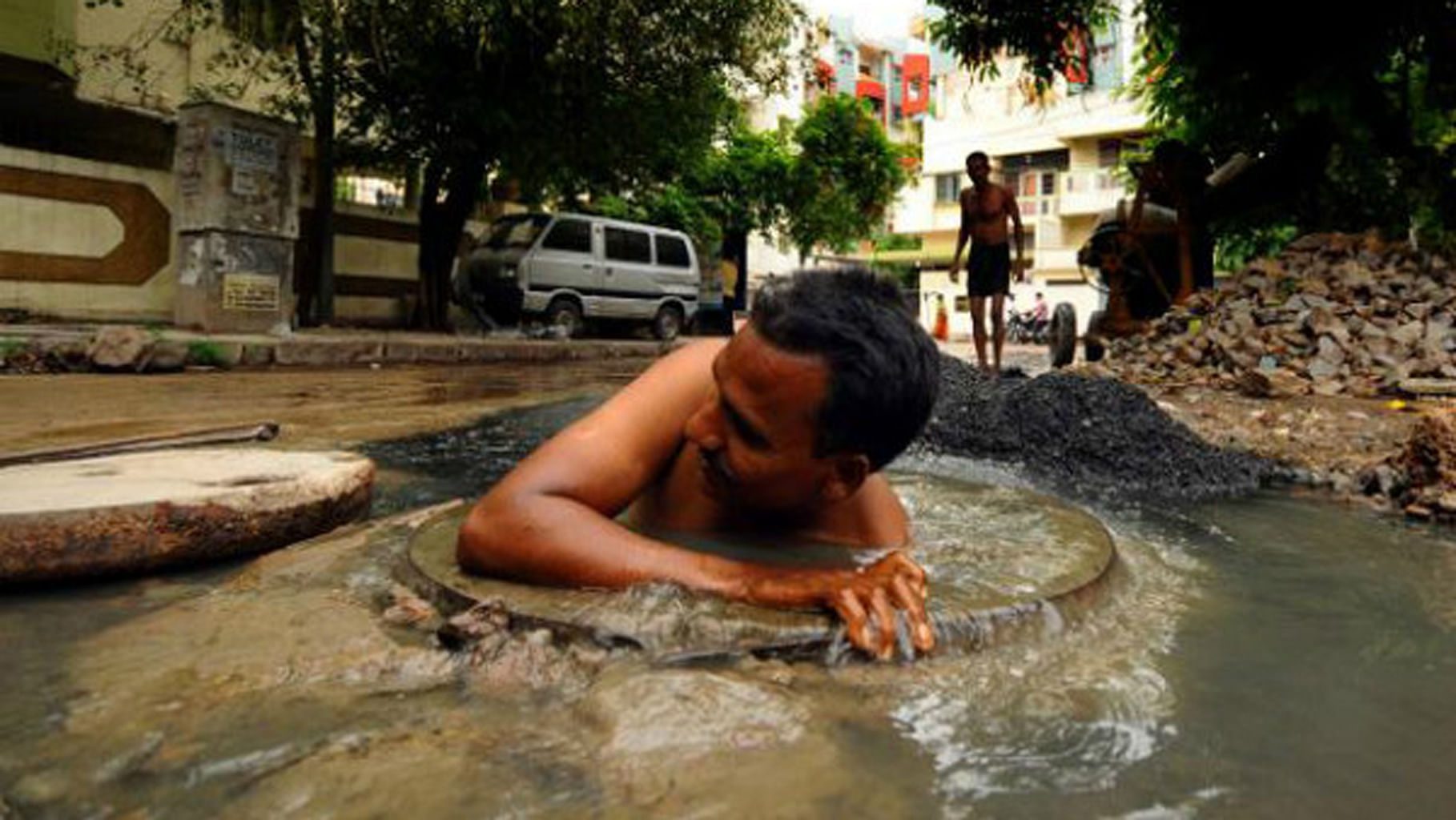 Sanitation workers are forced to work without any protective apparatus. (Photo Courtesy: <i>The News Minute</i>)