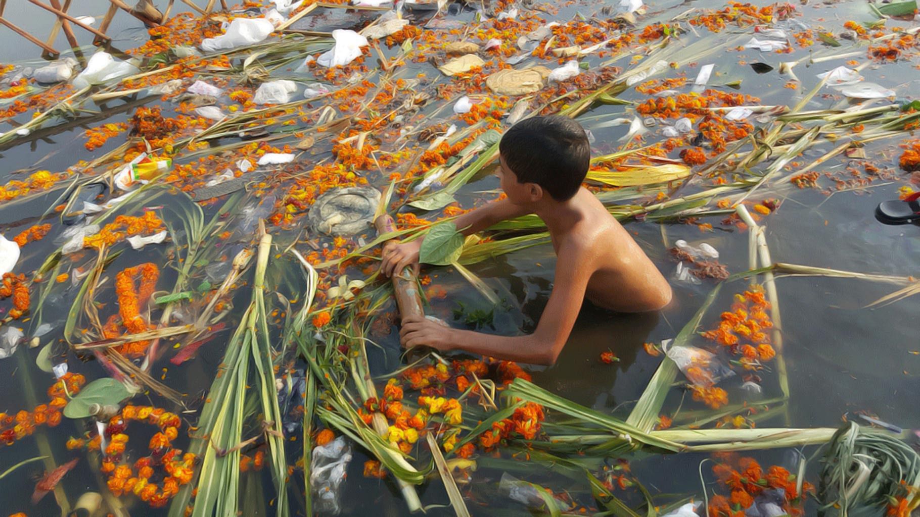 A boy swims through a polluted river. (Photo: The Quint)