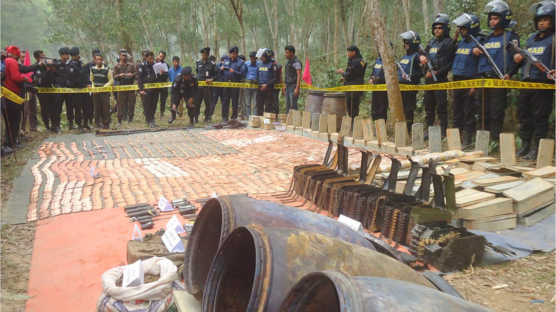 Bangladesh’s elite Rapid Action Battalion (RAB) on Monday recovered a huge cache of arms from Sherpur’s Jhenaigati Upazila. (Photo courtesy: bdnews24.com)