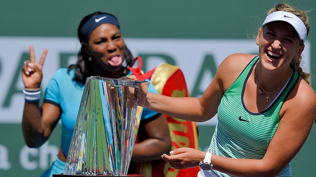 Serena Williams, left, jokes as Victoria Azarenka, of Belarus, right, poses with the trophy. (Photo: AP)