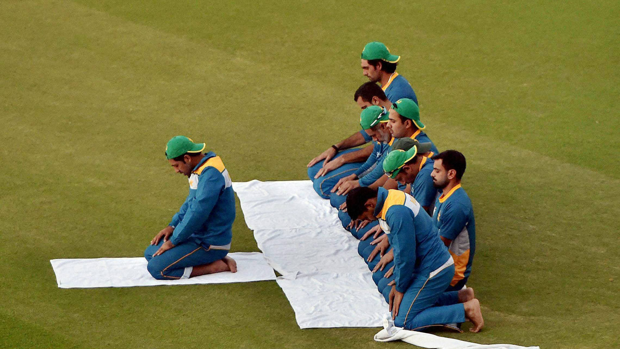 Pakistan’s cricket team offering namaz after a training session at PCA Mohali on the eve of World Cup T20 match against New Zealand on Monday. (Photo: PTI)
