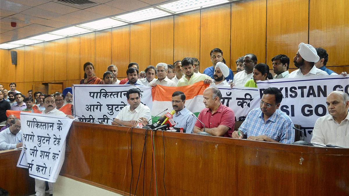 AAP MLAs showing banners against the Pakistan’s Joint Investigation Team’s visit to India, after presentation of the budget in the Assembly, in New Delhi on Monday. (Photo: PTI)