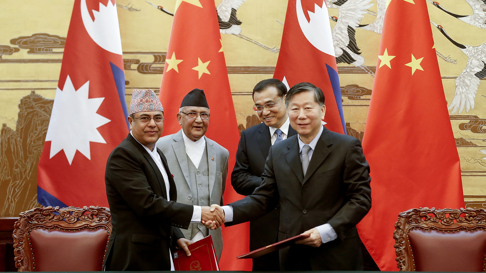 Chinese Premier Li Keqiang, rear right, with Nepal’s Prime Minister Khadga Prasad Oli, rear left, attend a signing ceremony at the Great Hall of the People Monday, 21 March 2016 in Beijing, China.&nbsp;