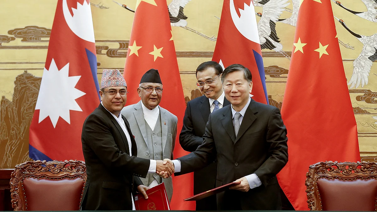 Chinese Premier Li Keqiang, rear right, with Nepal’s Prime Minister Khadga Prasad Oli, rear left, attend a signing ceremony at the Great Hall of the People Monday, 21 March 2016 in Beijing, China. 