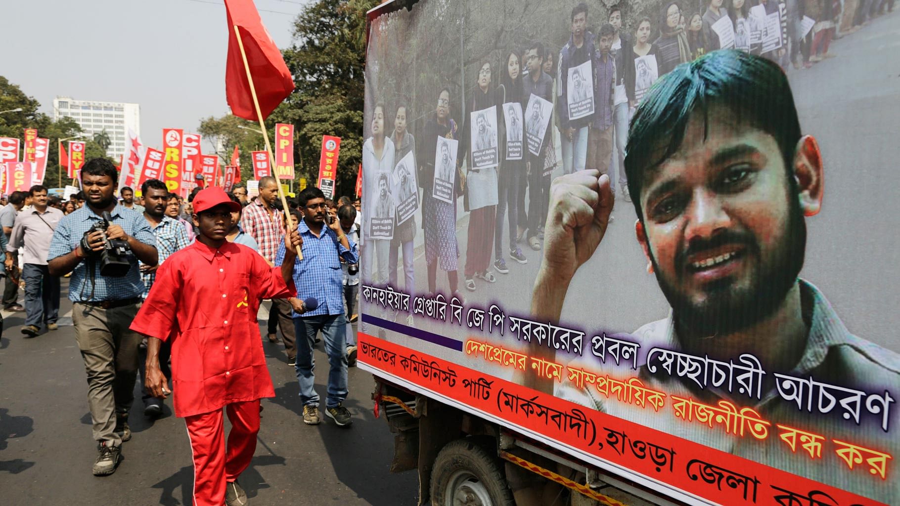 Left party workers walk along a tableau with a portrait of Kanhaiya Kumar in Kolkata. (Photo: AP)