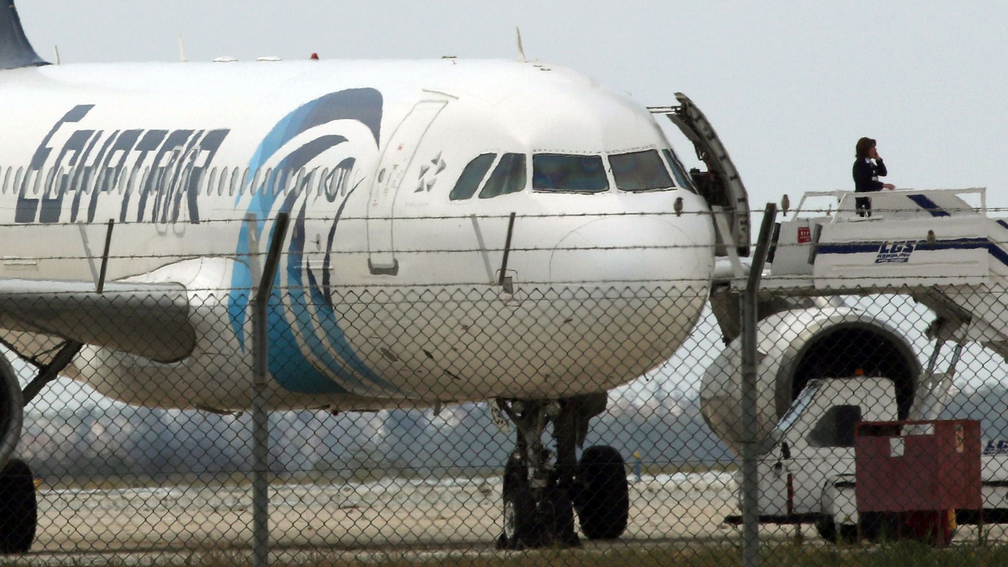 An official makes a call from the ramp of a hijacked Egyptair A320 Airbus at Larnaca Airport, Cyprus (Photo: Reuters)