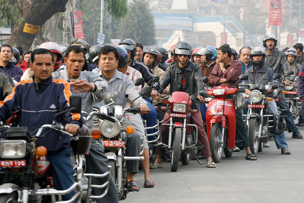 Nepali riders wait in a long queue to refill their bikes at a semi-government petrol station in Kathmandu, April 17 2006. (Photo: Reuters/Gopal Chitrakar)