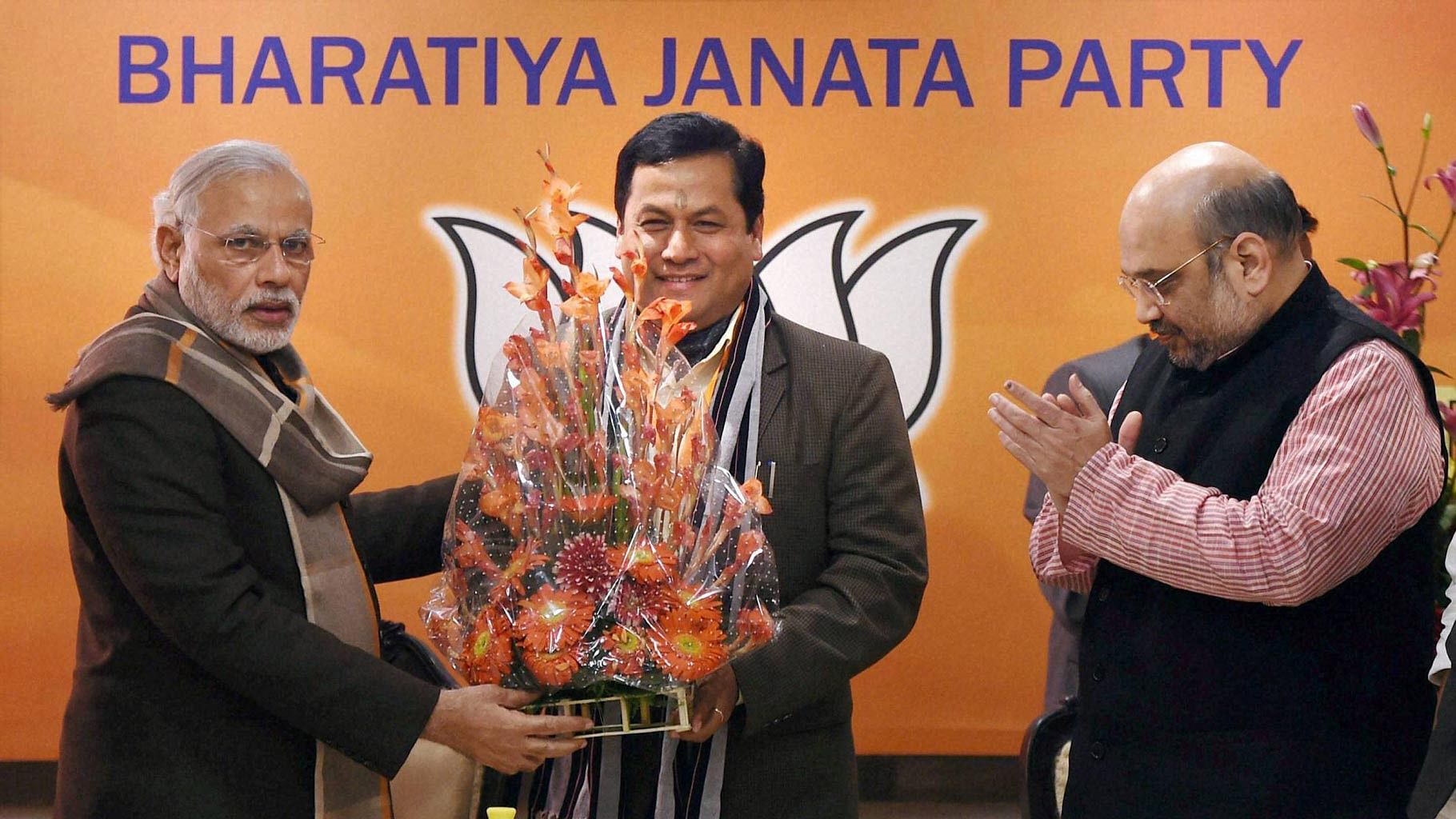 Prime Minister Narendra Modi greets party leader Sarbananda Sonowal after he was named BJP’s chief ministerial candidate for the upcoming Assam polls. (Photo: PTI)