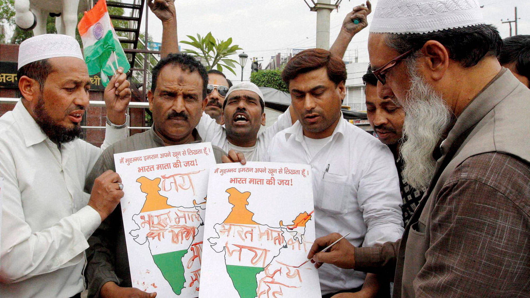 

People from Muslim community write <i>Bharat Mata ki Jai</i> with their blood as a way to show their disapproval with AIMIMs chief Asaduddin Owaisis recent comment. (Photo: PTI)