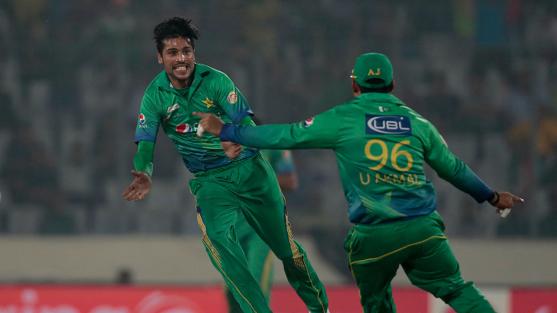 Pakistan’s Mohammad Amir (left) celebrates Suresh Raina’s wicket during the Asia Cup Twenty20 international cricket match in Dhaka, Bangladesh, Saturday, 27 February 2016. (Photo: AP)