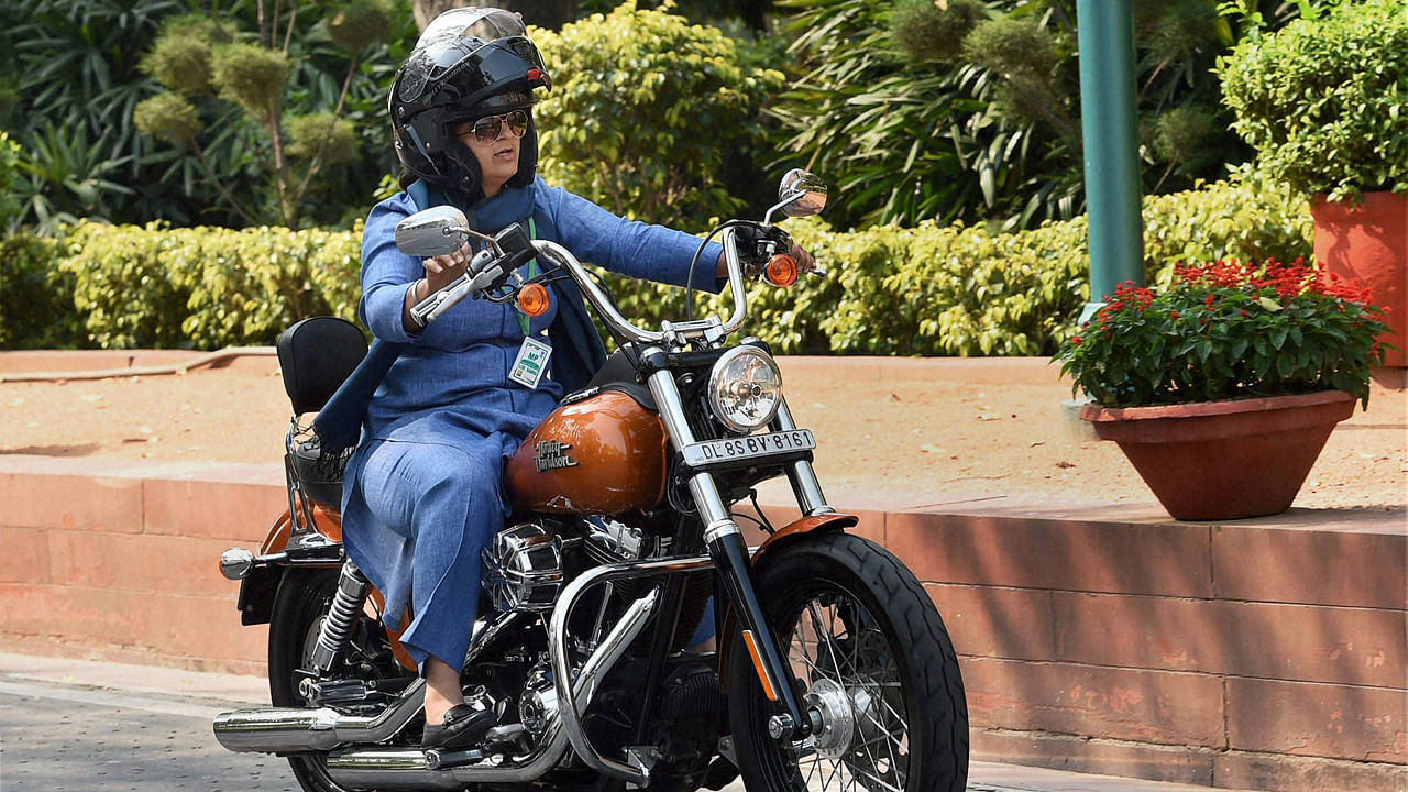 Ranjeet Ranjan, Lok Sabha MP from Supaul, Bihar, rides a Harley Davidson bike to Parliament in New Delhi on International Women’s Day on Tuesday. (Photo: PTI)