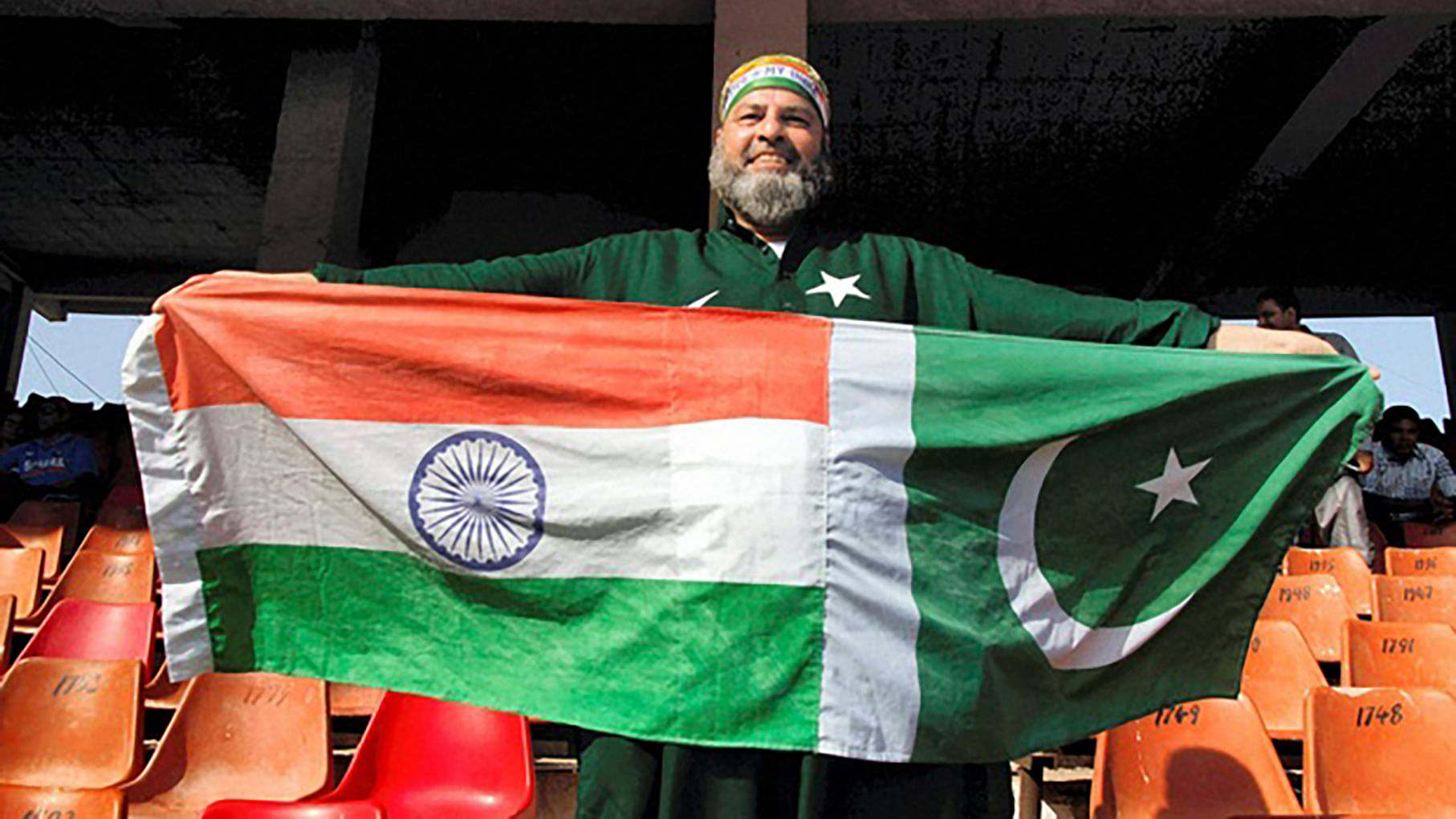 Mohammad Bashir, a cricket fan displays flags of both India and Pakistan during a T20 cricket match between India and Pakistan in Ahmedabad. (Photo: PTI)