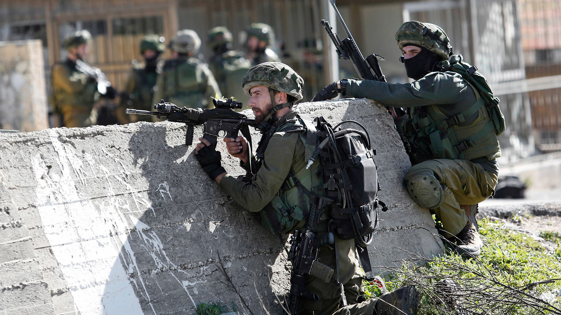 In this  file photo (shot on Monday, 15  February 2016), Israeli soldiers take positions during a raid to arrest a Palestinian at the Amari Palestinian refugee camp, near the West Bank (Photo: AP)