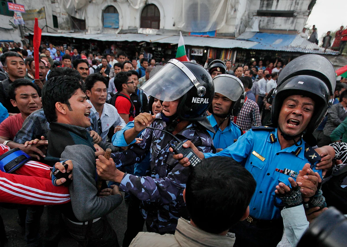Nepalese protesters clash with policemen after burning a copy of the new constitution during the protest organized by splinter of the Maoist party, alliance of ethnic group and Madhesi party, in Kathmandu, Nepal, September 2015. (Photo: AP/Niranjan Shrestha)